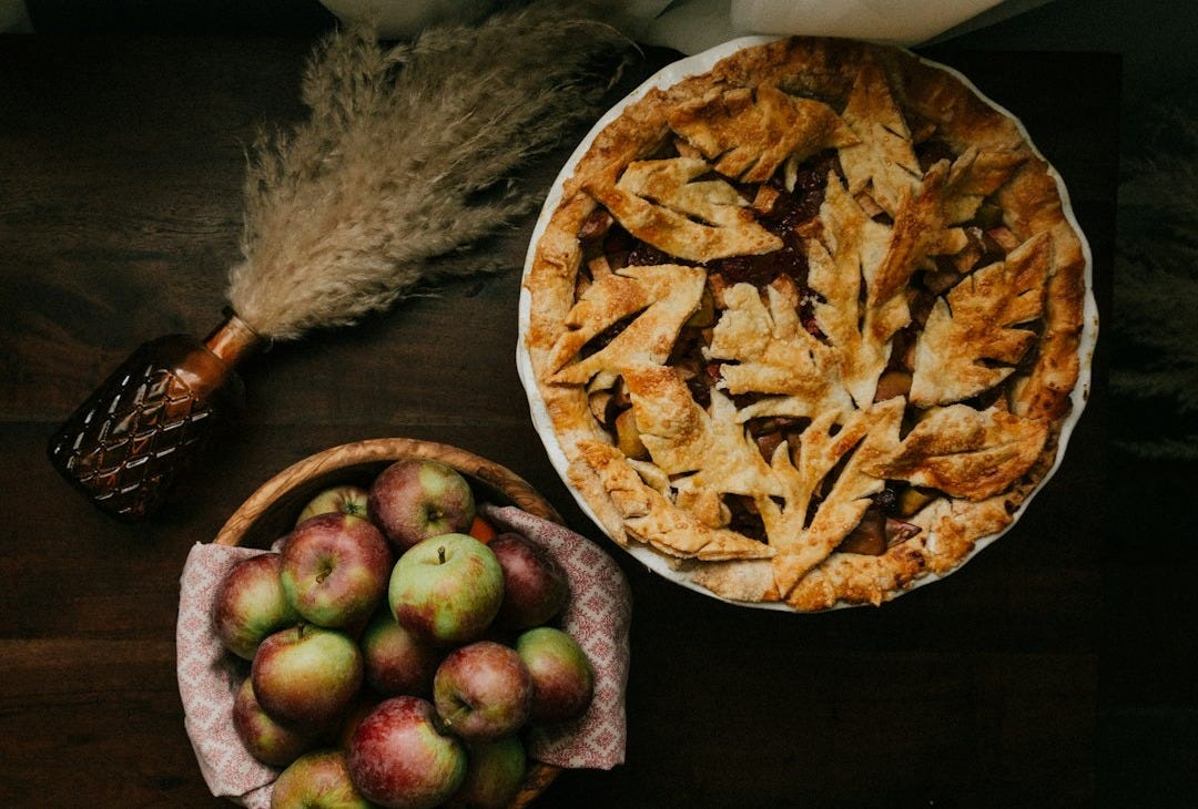 brown and green round fruit on brown wooden table