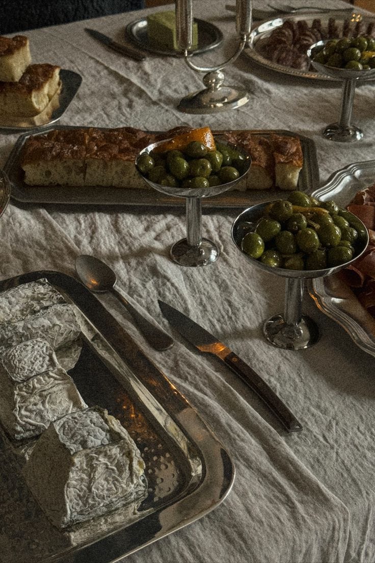 This may contain: a table topped with lots of different types of food on trays next to each other