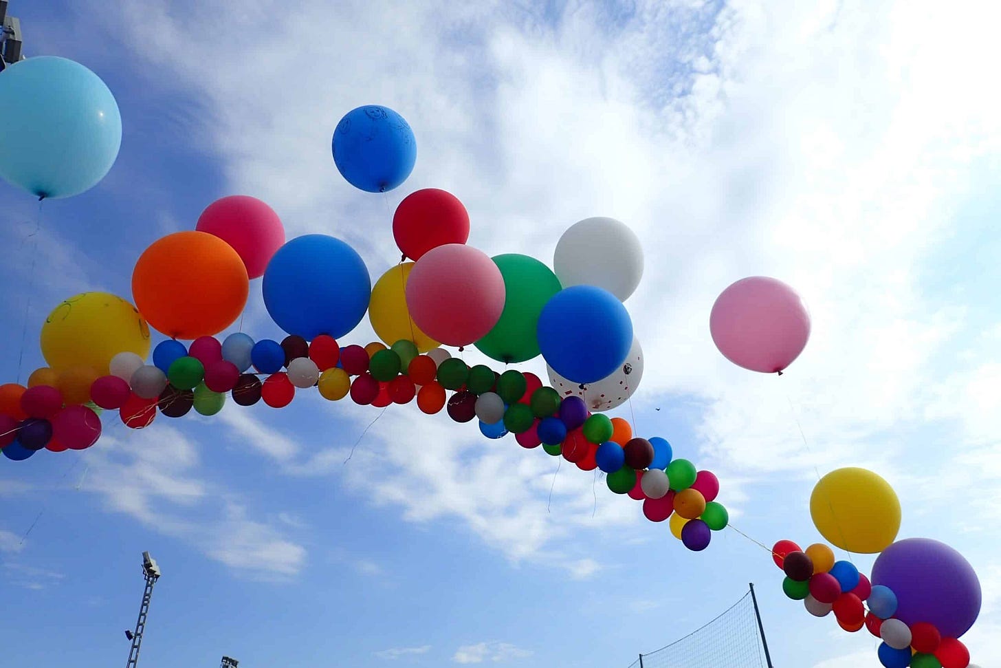 A colorful bunch of balloons soaring in the sky, Colorful balloons soaring high in the sky (Shutterstock)