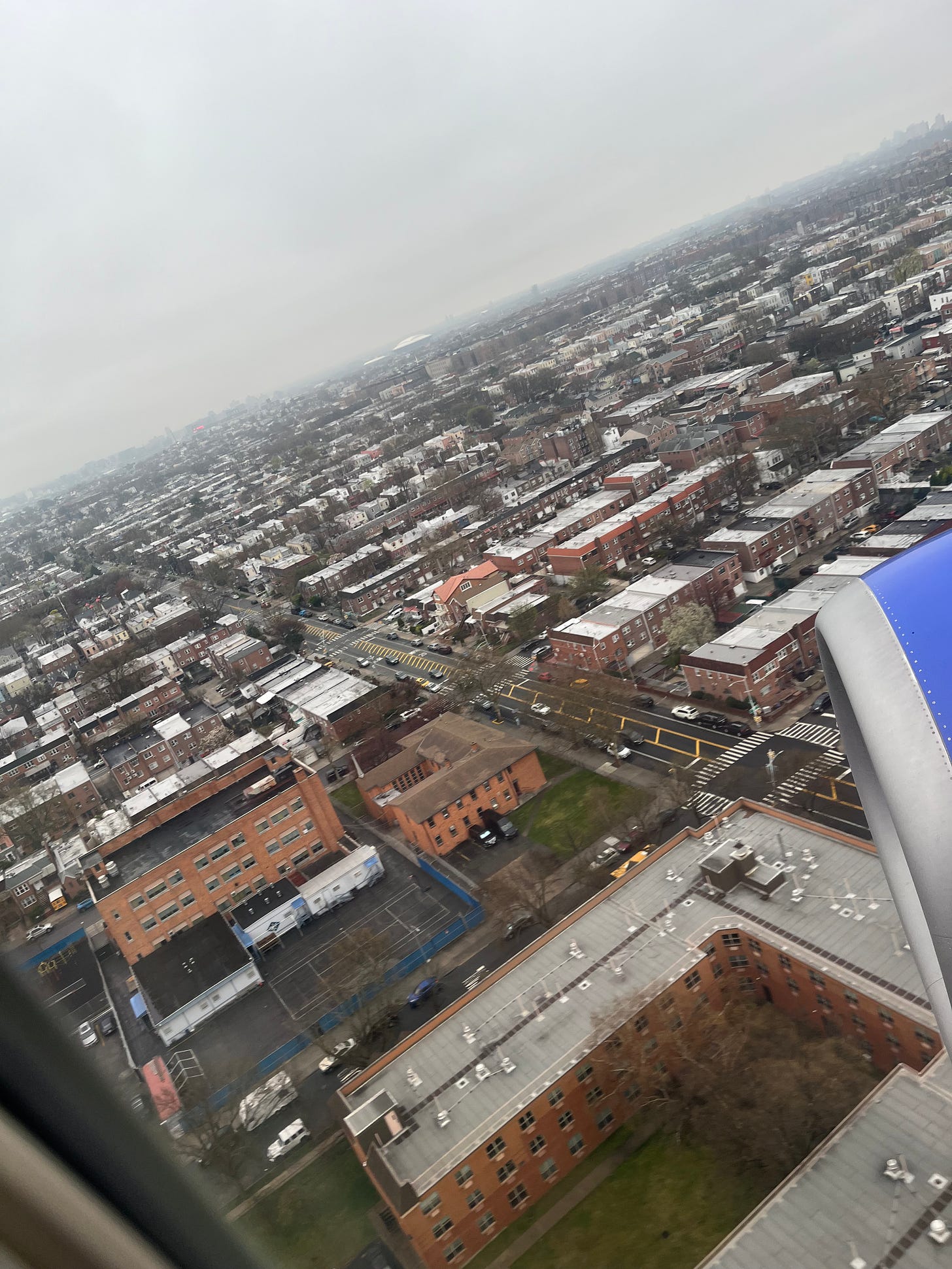Picture taken outside plane window of all the houses flying into Queens