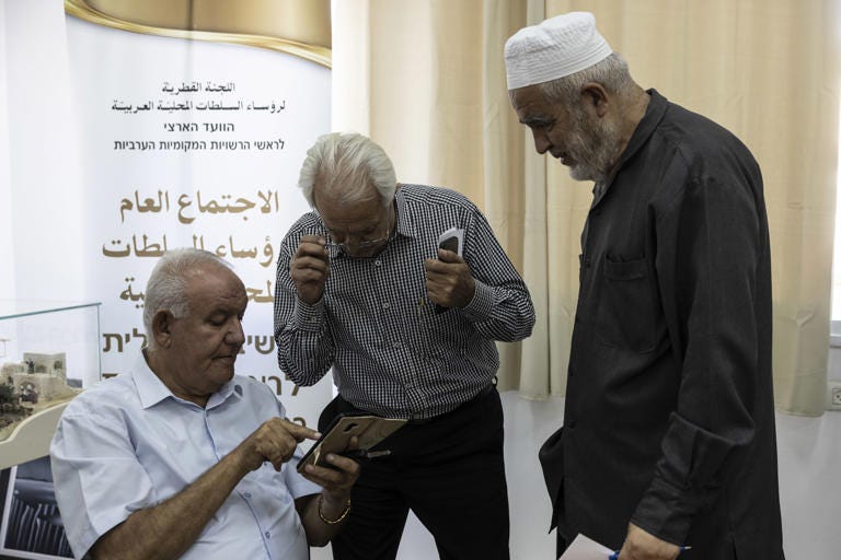 Raed Salah, right, speaks with members of the Higher Arab Monitoring Committee at a meeting in Nazareth on Thursday. (Heidi Levine for The Washington Post)