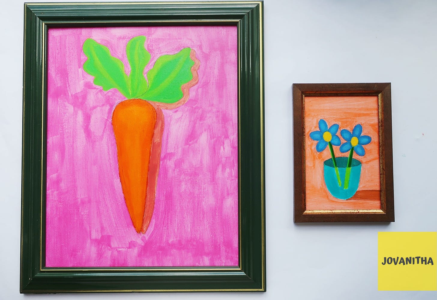 An orange carrot on a pink background and blue forget-me-not flowers on an orange background in vintage frames