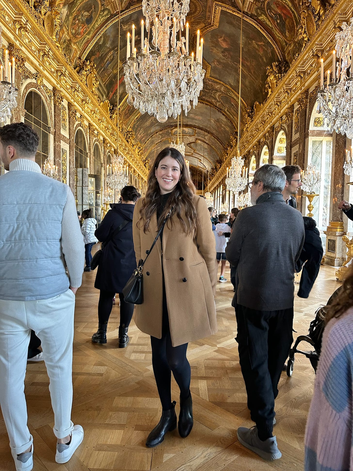 Alex standing in the Hall of Mirrors at Versailles