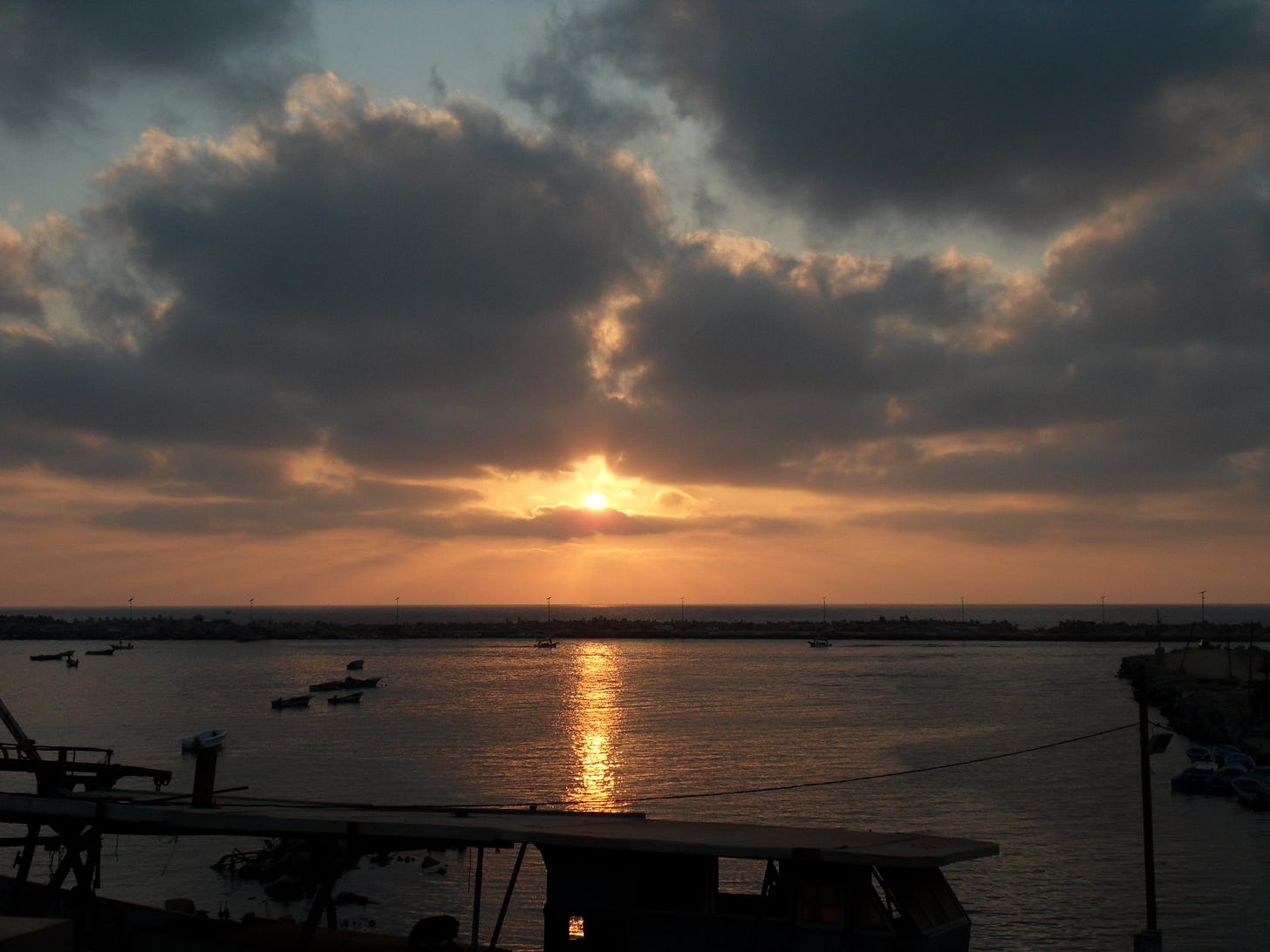 Sunset over the Mediterranean Sea with a boat in the foreground