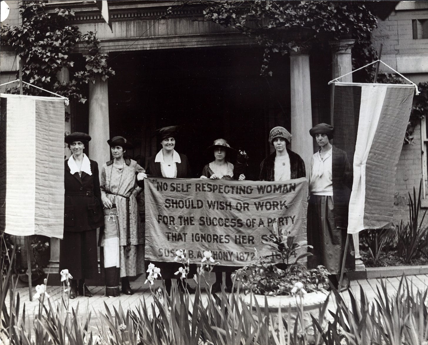 suffragists holding a banner with a Susan B Anthony quote