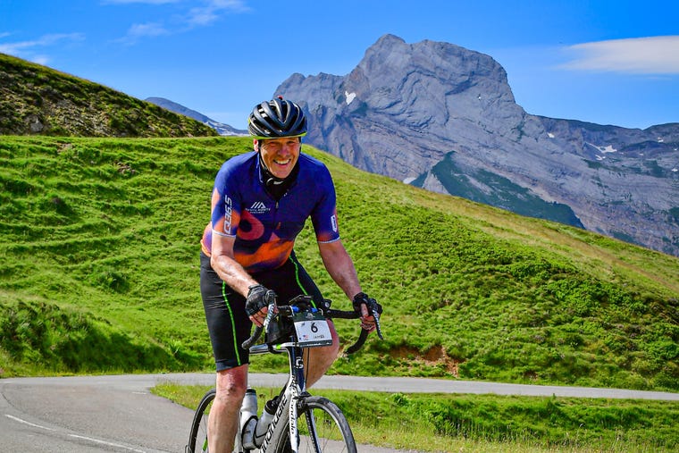 Father Jim Sullivan bikes amid a spectatular backdrop on Day 5.