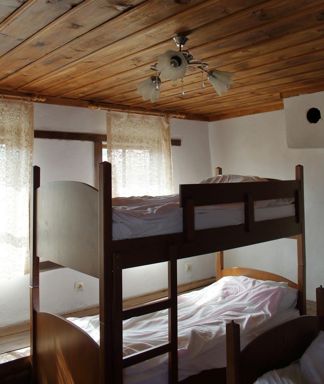 a room with bunk beds and a ceiling fan