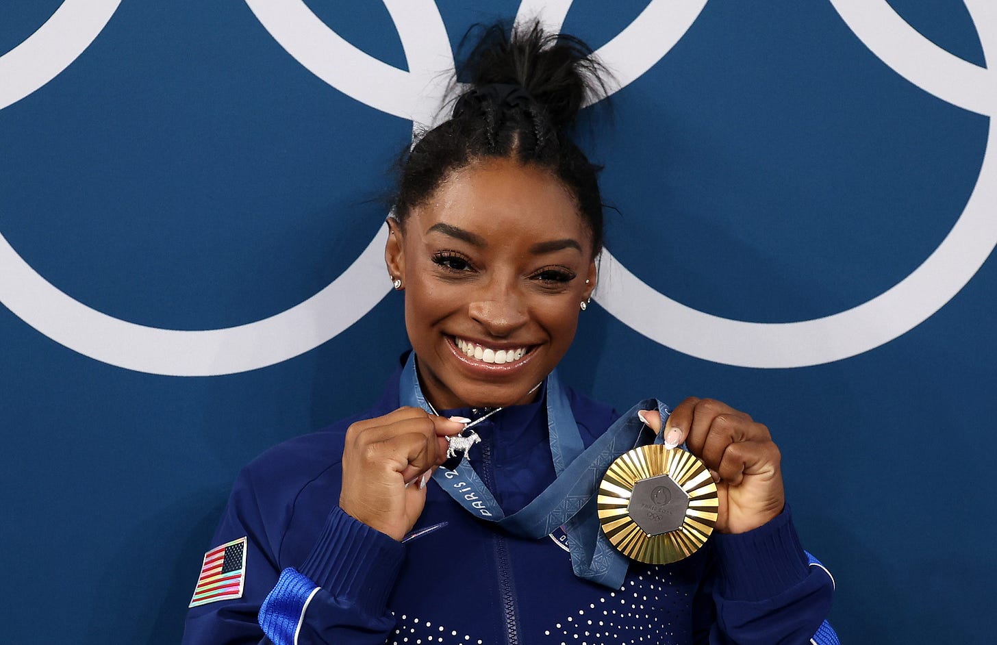 Simon Biles wearing a gold medal