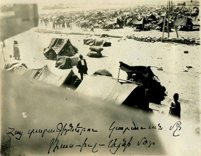 Photo of refugee camp with tents and Armenian inscription