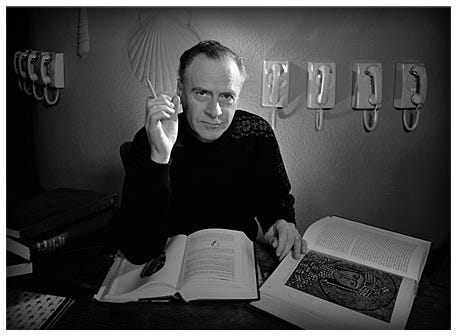 Marshall McLuhan in a black turtleneck at desk