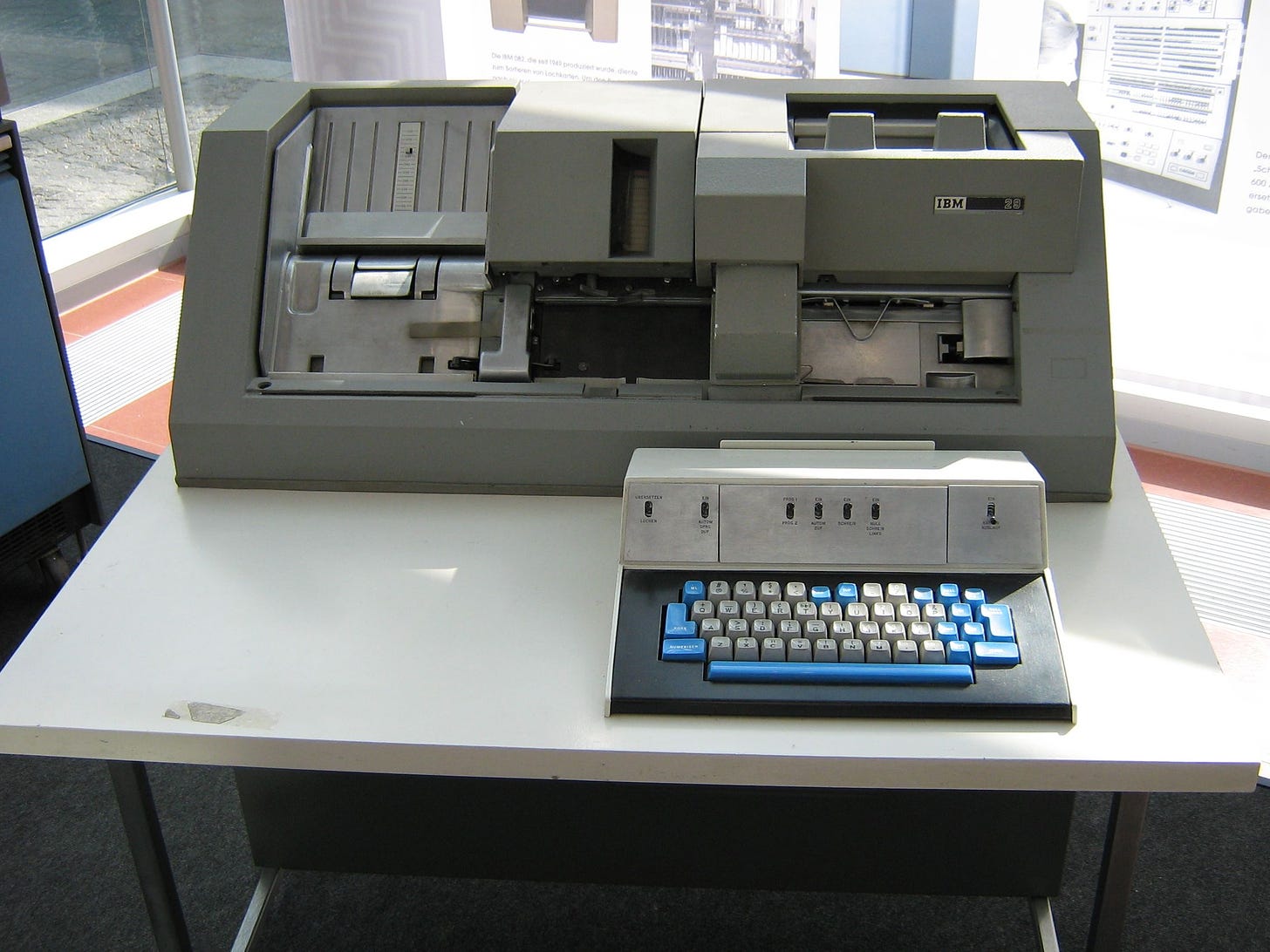 Two pieces, keyboard and card hopper. The keyboard is relatively small; the hopper is 3-5 feet side; 1-2 feet tall, and 1-2 feed deep.