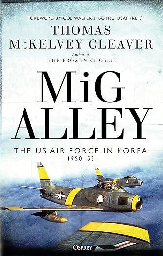 Color book cover of “MIG Alley: The U.S. Air Force in Korea 1950-1953 by Thomas McKelvey Cleaver featuring three F-86 Sabre jets in formation against a blue sky over a muted grey-brown terrain. The Sabres are standard metallic aluminum colored with bright yellow identification bands on the vertical stabilizer, across the mid-section of the fuselage, on the wings and around the jet engine intake.