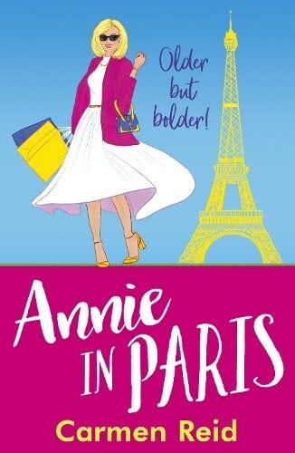 book cover for Annie in Paris by Carmen Reid. A young woman wearing a white dress and pink jacket is carrying a yellow handbag stood in front of the Eiffel Tower