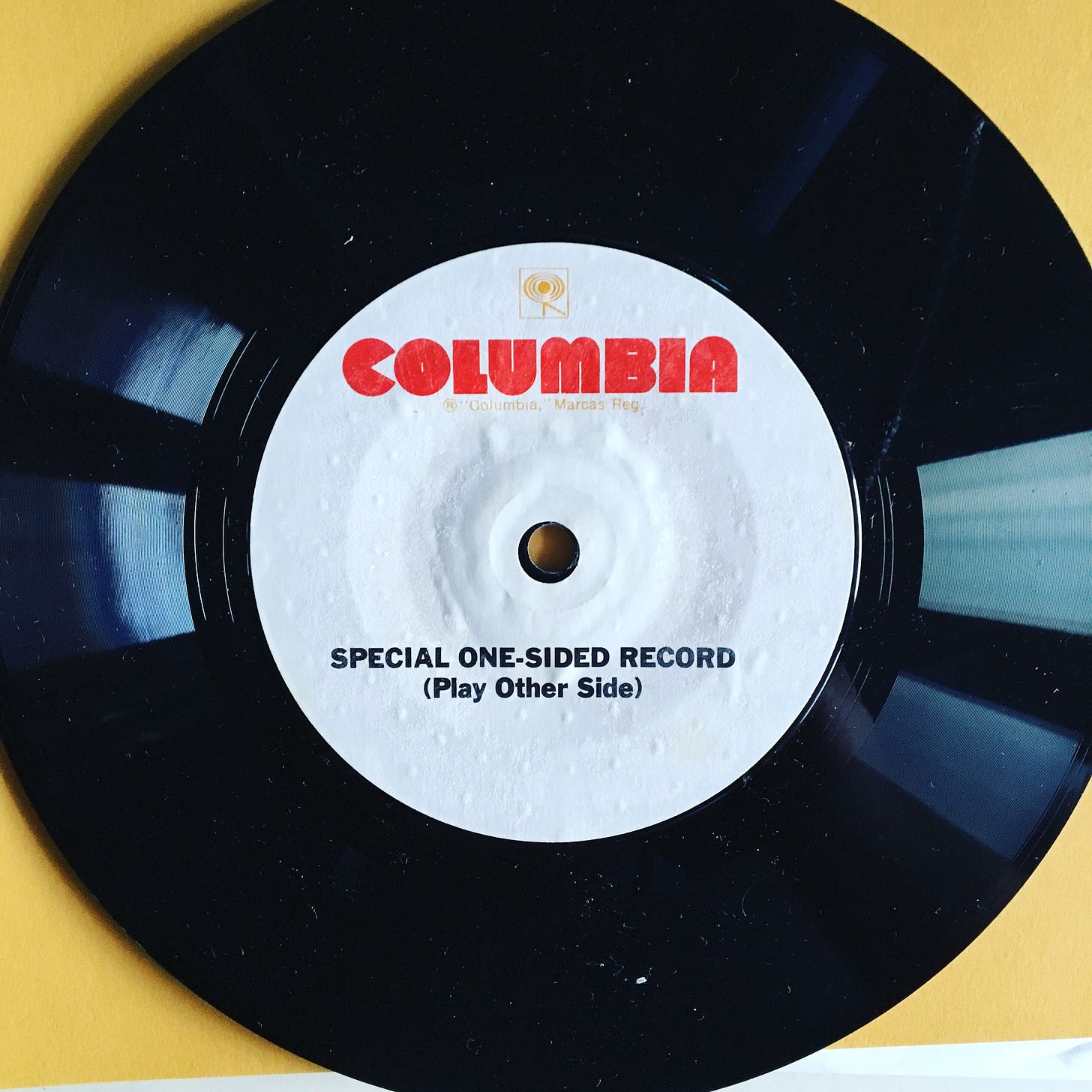 A vinyl record with a label that says "special one-sided record (play other side)"