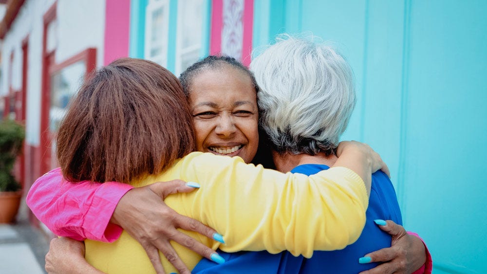 Friends reconciling with a group hug.