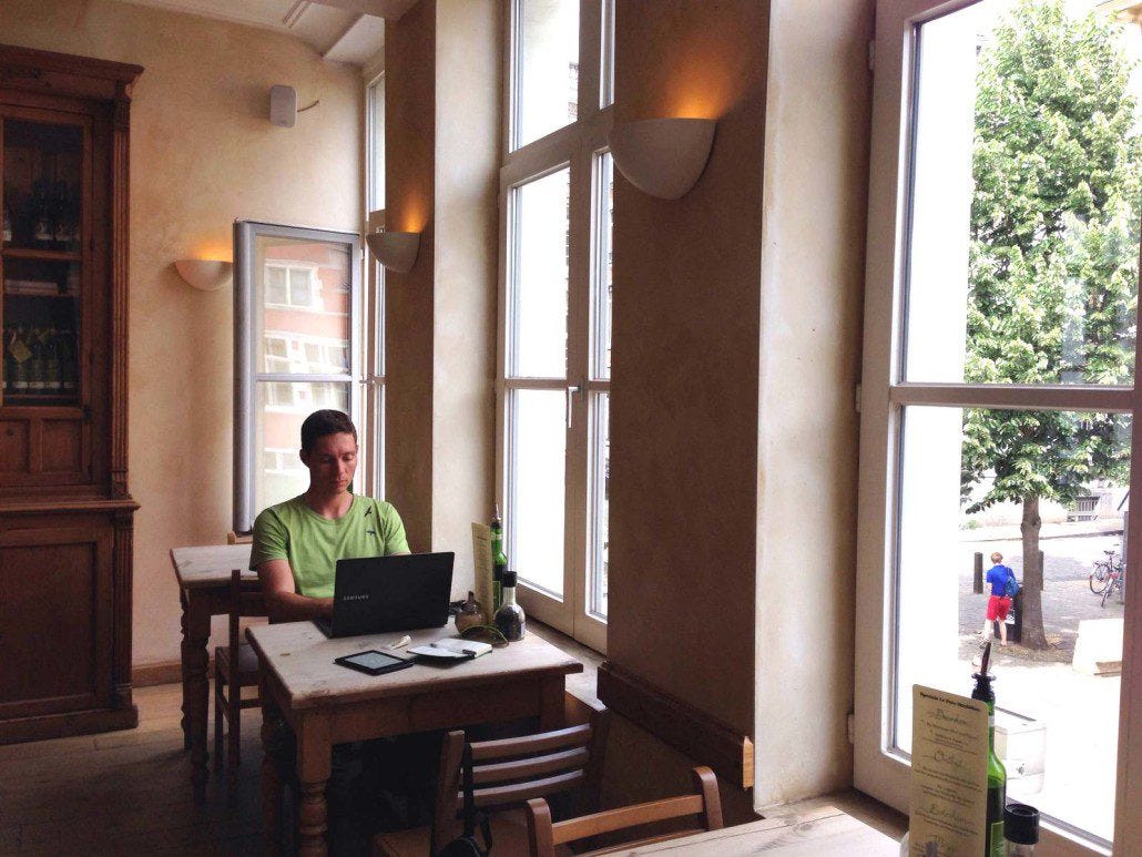Getting some work done in a cafe in Belgium with live violin music from a street musician below the window.