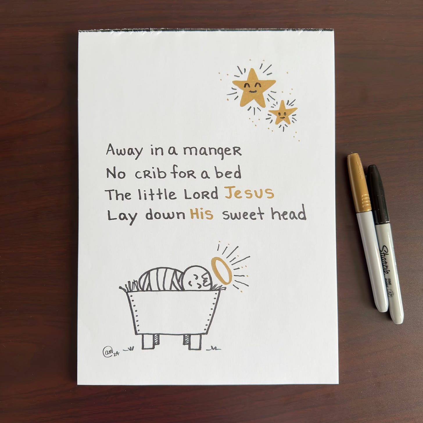 An illustration of lyrics from the song "Away in a Manger."