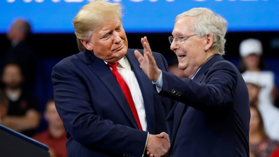 President Donald Trump shakes hands with Senator Mitch McConnell (R-KY) at a Keep America Great Rally at the Rupp Arena in Lexington, Kentucky, November 4, 2019.