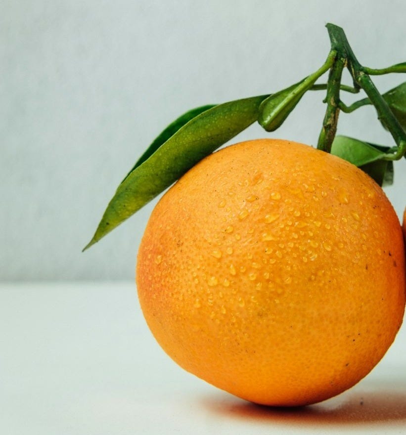 two orange fruits on table