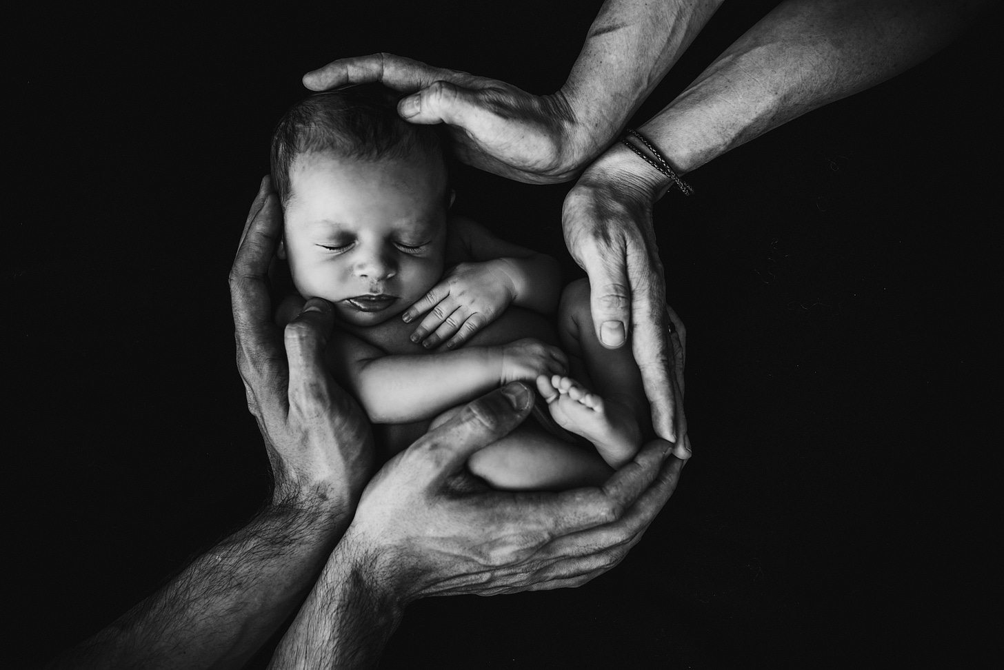 Baby held in adult hands