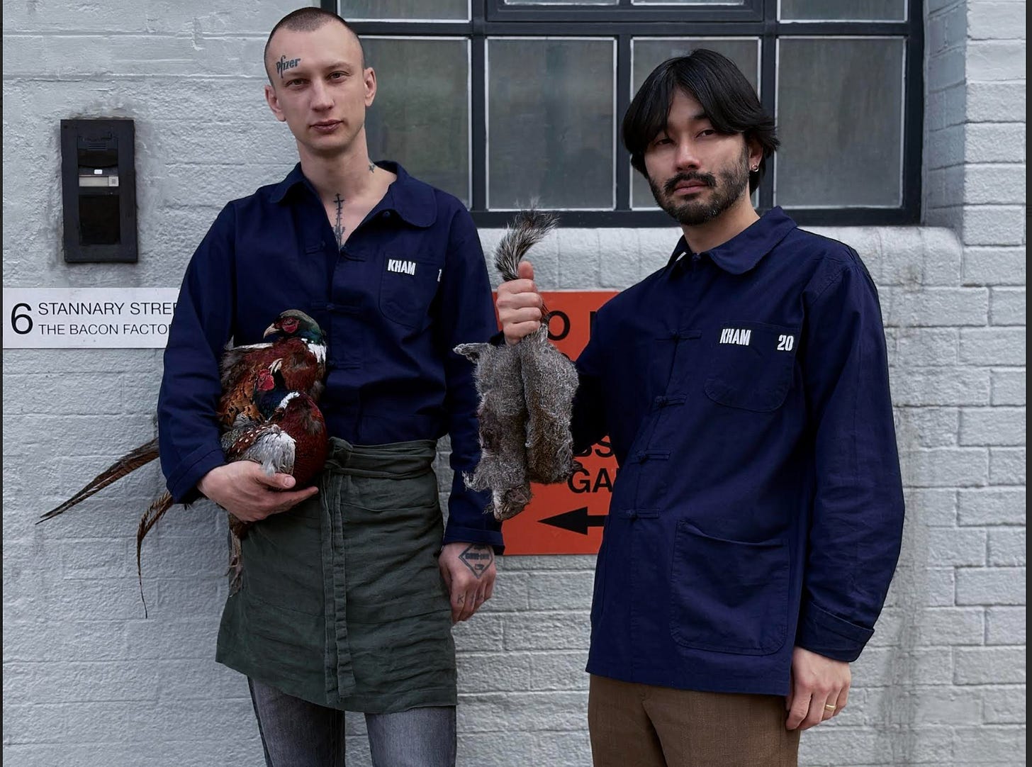 Two men holding a rooster and a bird

AI-generated content may be incorrect.