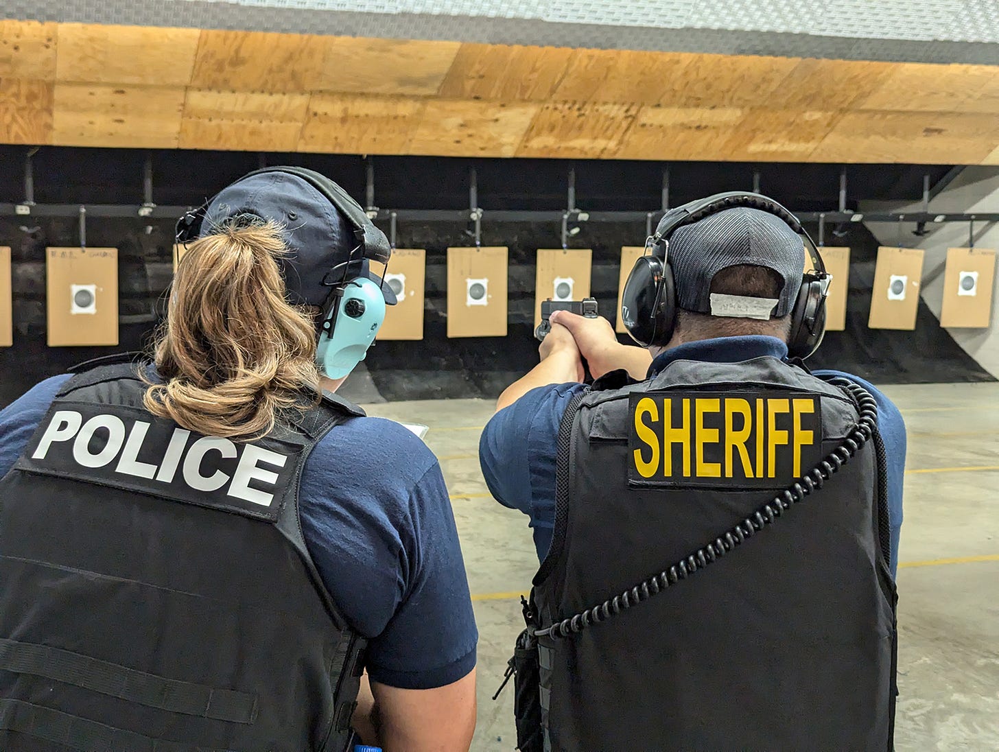 An officer recruit fires a pistol during firearms training at the George S. Mickelson Law Enforcement Center in Pierre on July 8, 2024. (John Hult/South Dakota Searchlight)