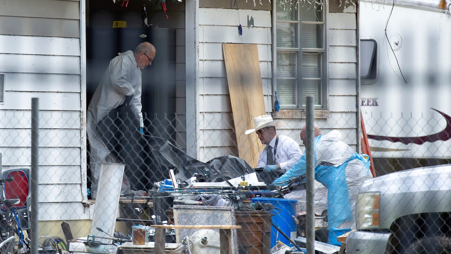 Law enforcement authorities removing bodies from a scene where five people were shot the night before Saturday, April 29, 2023, in Cleveland, TX.
