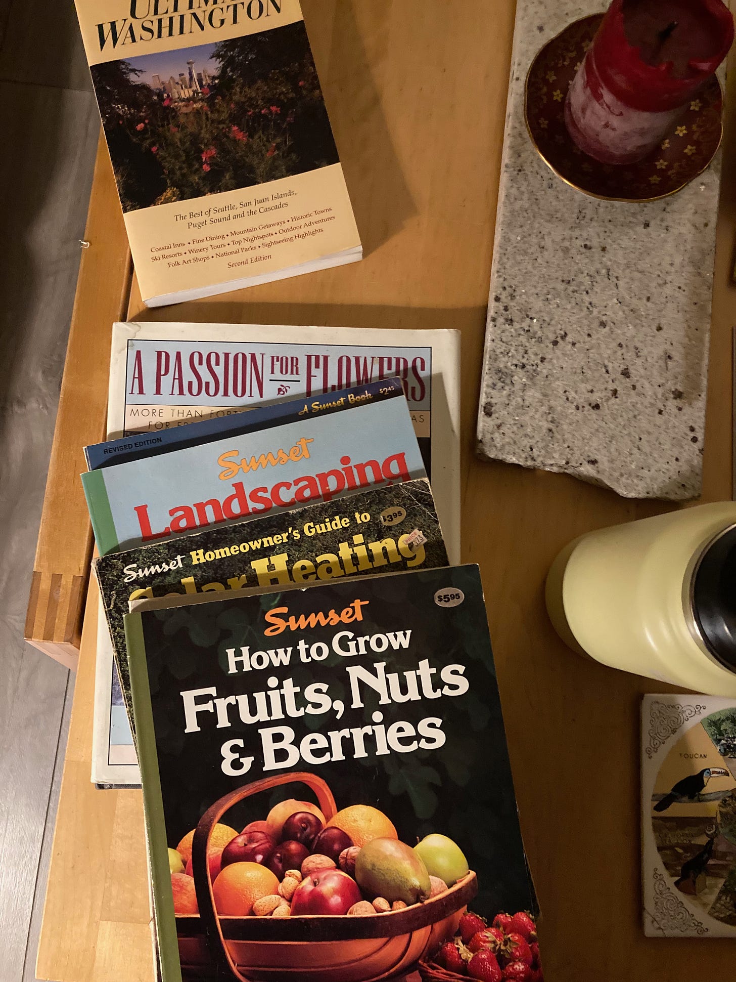 A stack of Sunset Magazine books from the 70's; the top one is about how to grow fruits, nuts, and berries