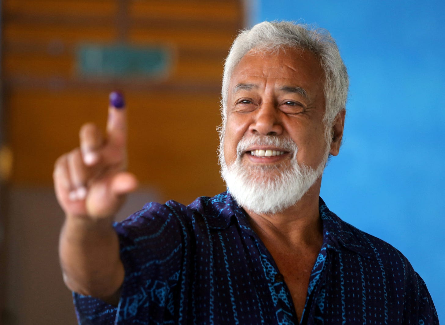 Xanana Gusmao, independence hero and the country's first president, shows his ink-stained finger after voting in the general election in Dili