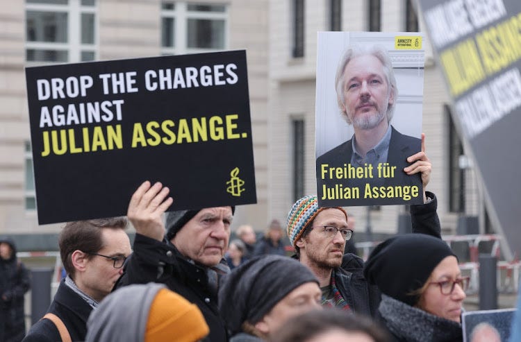 People gather with signs that read: ’“Freedom for Julian Assange” to demand freedom for Wikileaks founder Julian Assange on February 20, 2024 in Berlin, Germany. Assange and his lawyers are appealing on February 20 in a London court against his possible extradition to the US, where he would face charges of espionage and a likely lengthy prison term for his publication of secret documents related to US military activity in Iraq and Afghanistan. His supporters see him as a whistleblower who brought war crimes to light. Picture: SEAN GALLUP/GETTY IMAGES