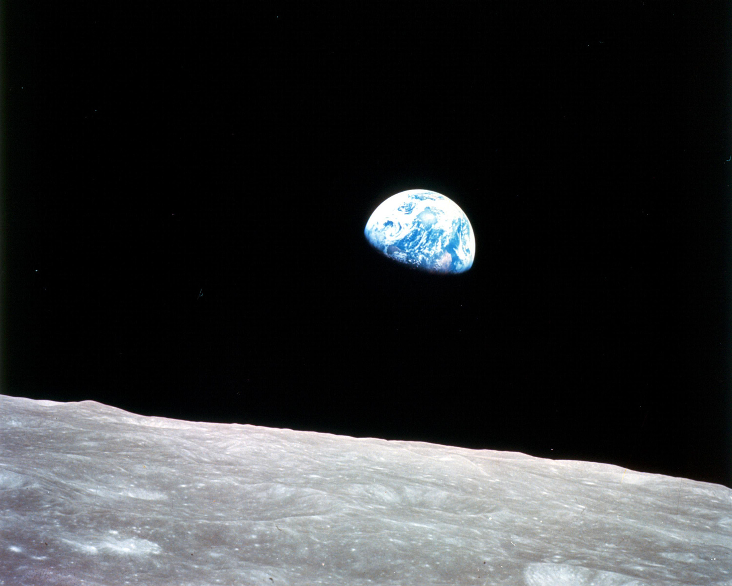 Apollo 8, the first manned mission to the moon, entered lunar orbit on Christmas Eve, Dec. 24, 1968. That evening, the astronauts-Commander Frank Borman, Command Module Pilot Jim Lovell, and Lunar Module Pilot William Anders-held a live broadcast from lunar orbit, in which they showed pictures of the Earth and moon as seen from their spacecraft.