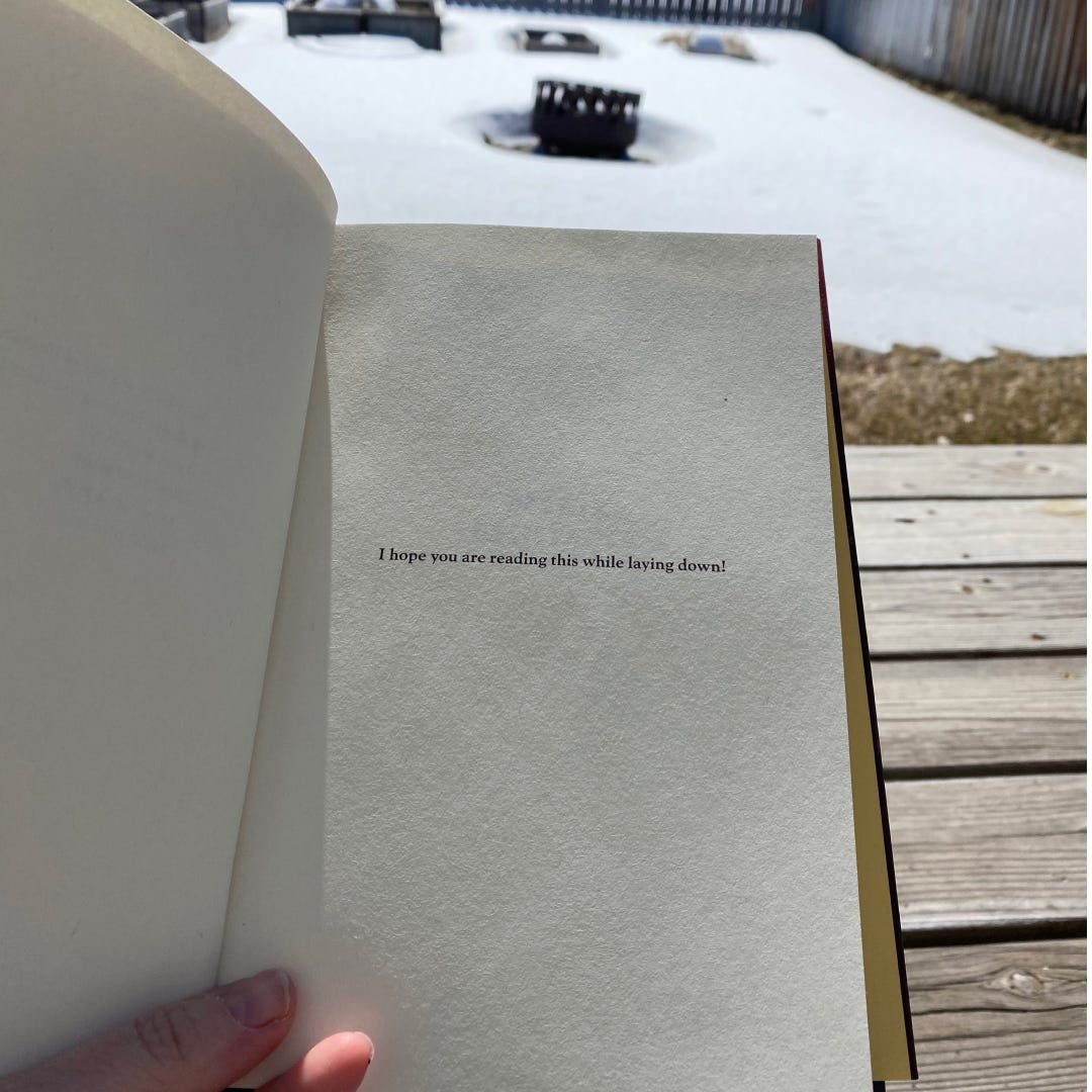 Photo of the first page of Rest is Resistance that reads "I hope you are reading this while laying down!"