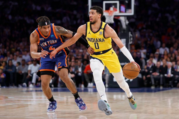 Tyrese Haliburton of the Indiana Pacers dribbles the ball against Miles McBride of the New York Knicks during the second quarter in Game Five of the...