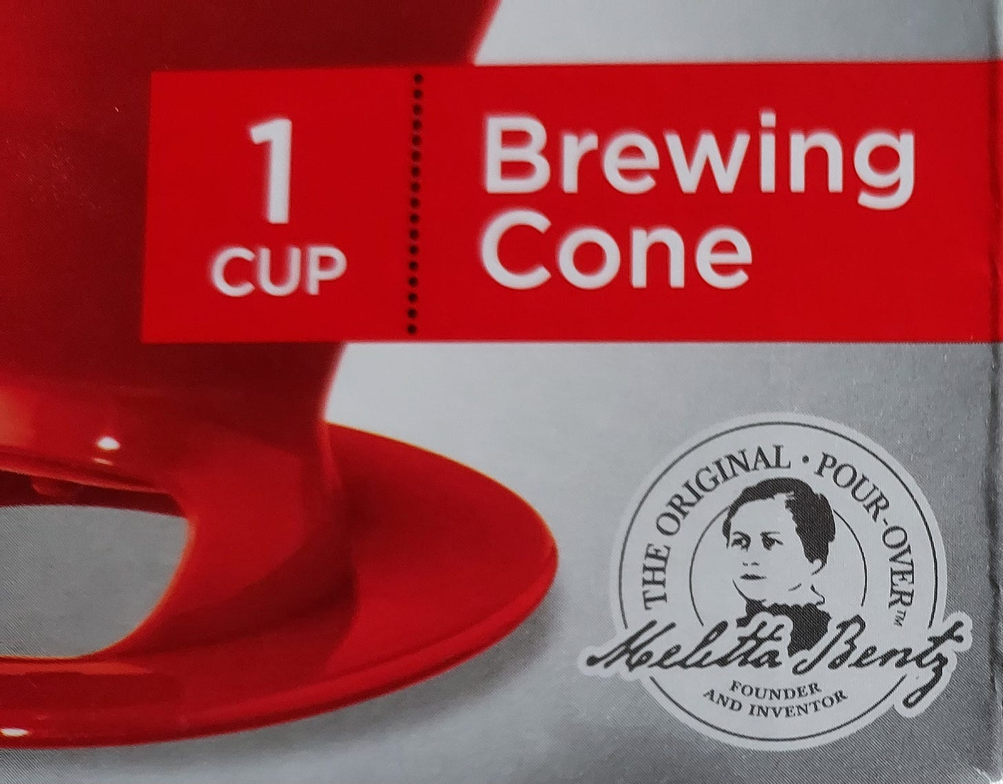 A close-up of the front of a Melitta coffee dripper package showing a badge with the founder and inventor Melitta Bentz and the proclamation that it is the original pour-over.