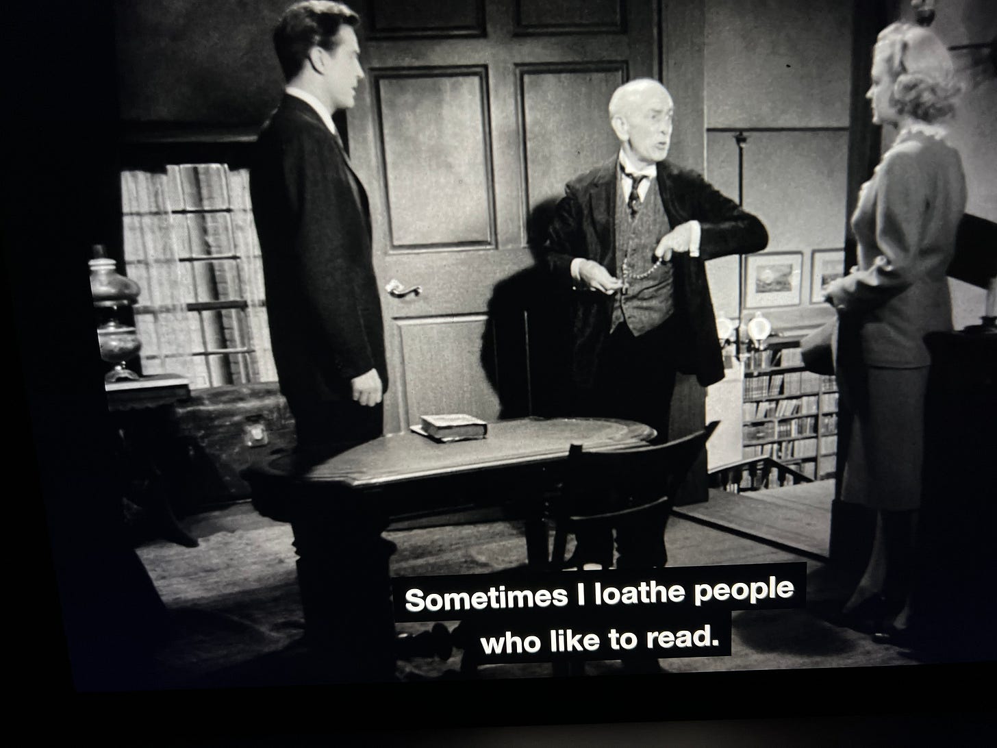 Two men and women standing in a bookstore. Closed caption reads" Sometimes I loathe people who like to read." From Ministry of Fear (1944)