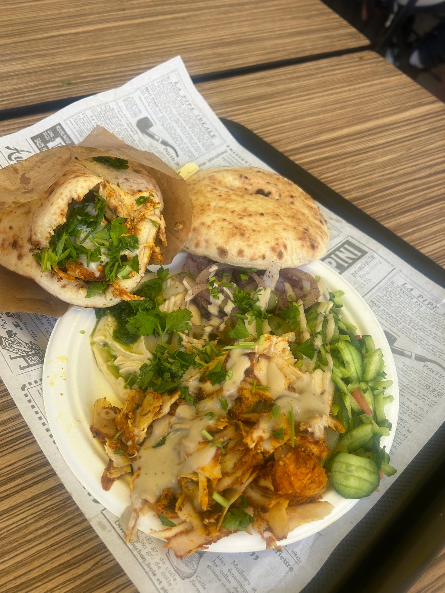 A picture of a pita sandwich and a chicken shawarma plate.