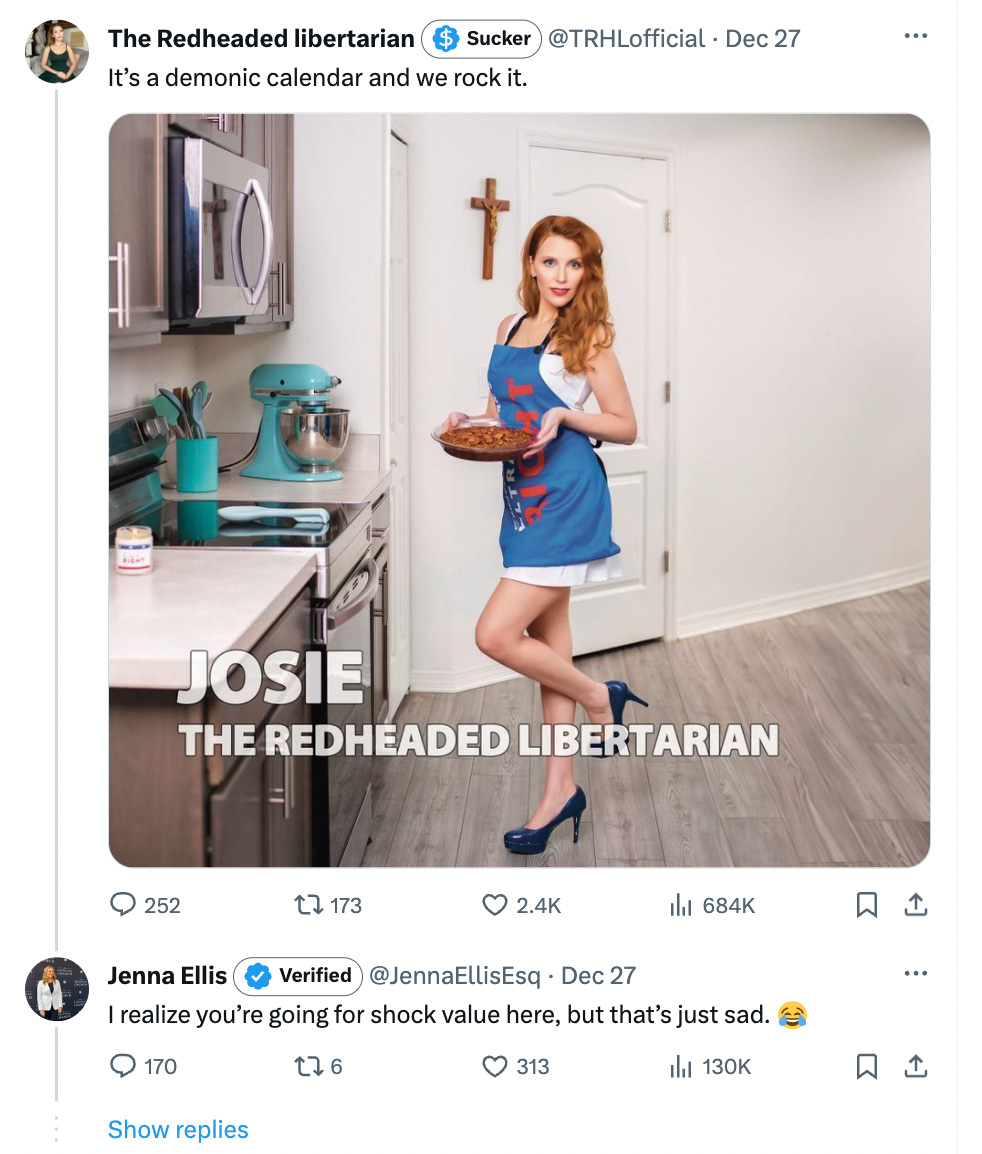 the redheaded libertarian: it's a demonic calendar and we rock it. picture of redheaded woman holding a pie in a kitchen next to a cross