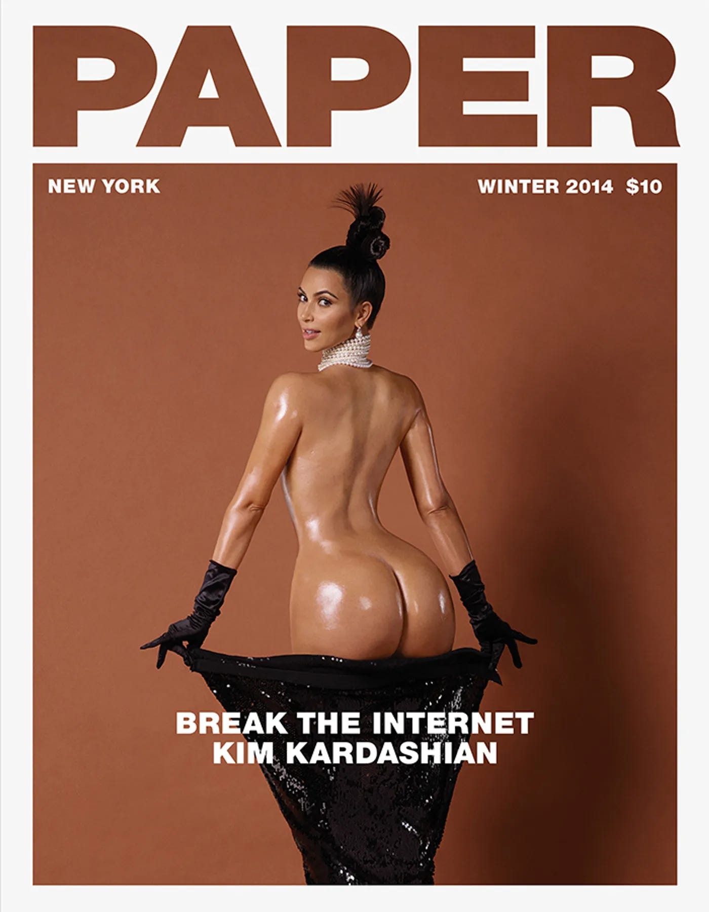 Kim Kardasian naked, looking over her shoulder, revealing her oiled behind on the cover of the winter issue of Paper Magazine