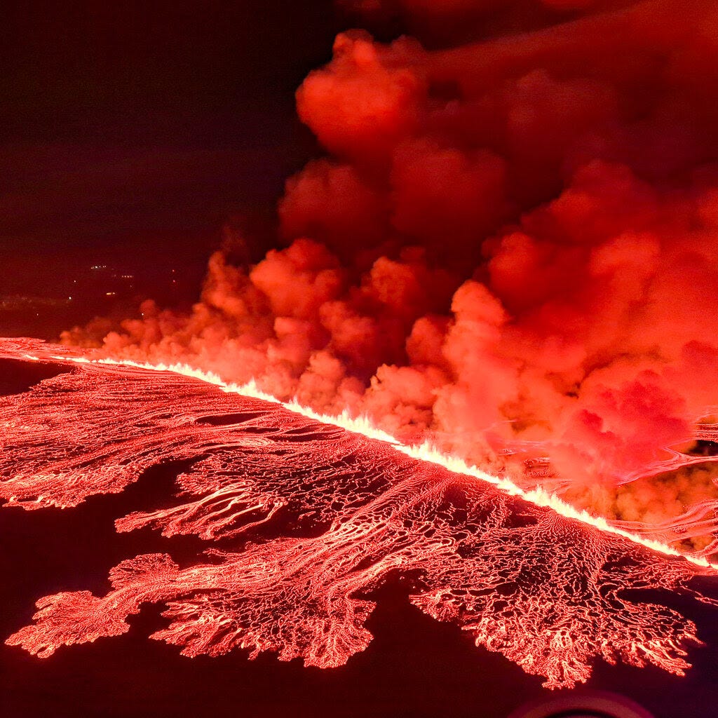 Reddish-orange lava and smoke.