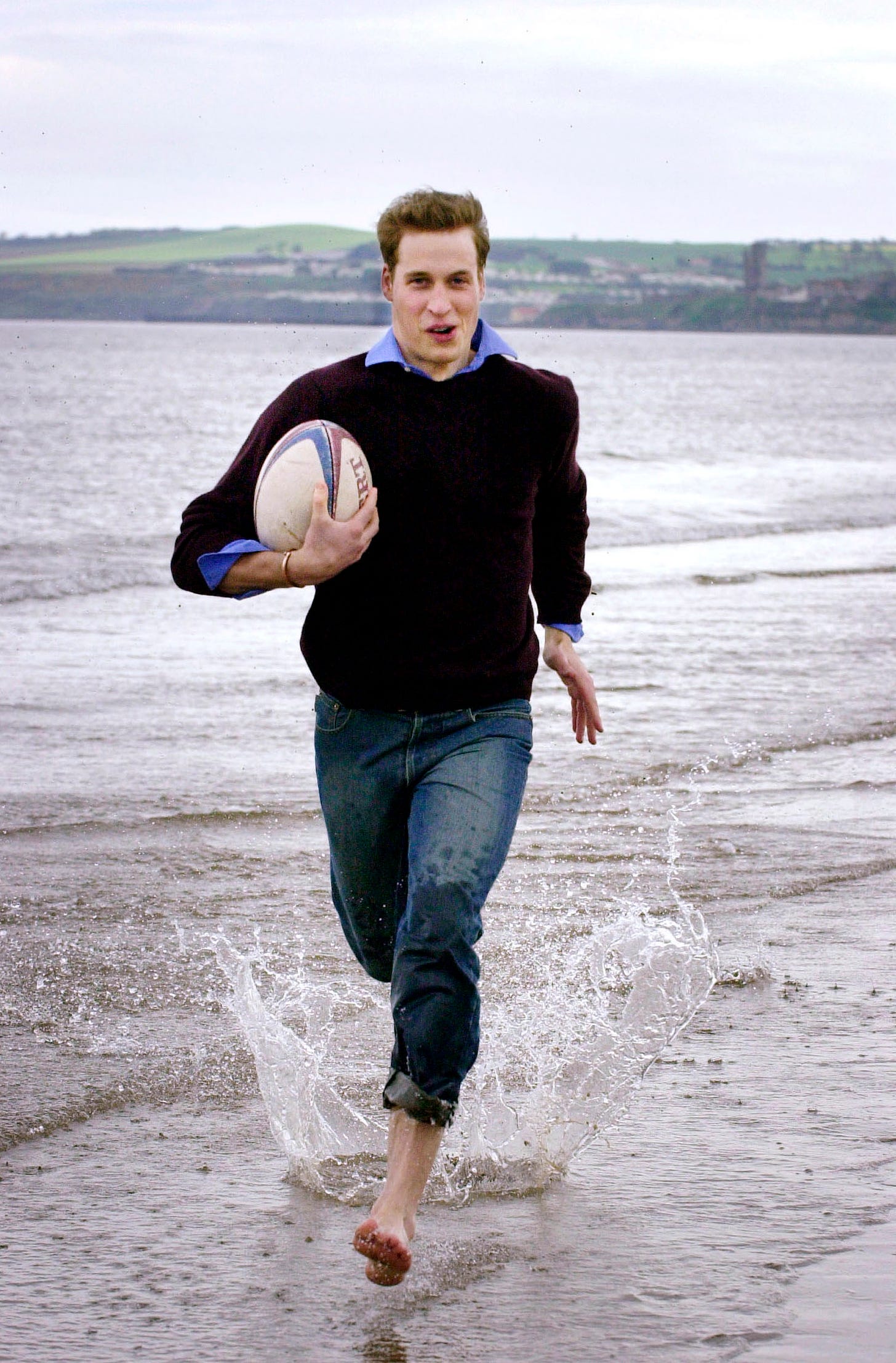 prince william running along beach in scotland