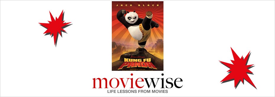 A movie poster featuring Po, the panda bear in the movie franchise “Kung Fu Panda,” hangs between two red bursts.