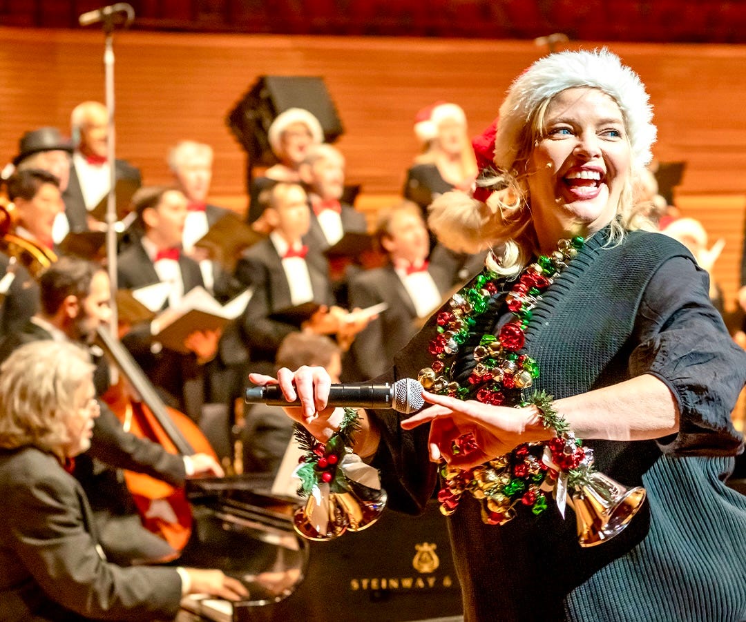 A festive woman leads a holiday sing-along