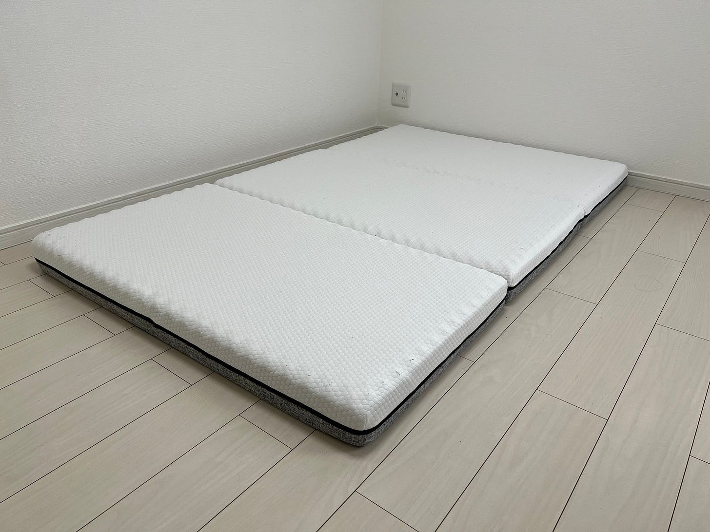 A photo of a folding mattress in a Japanese bedroom.