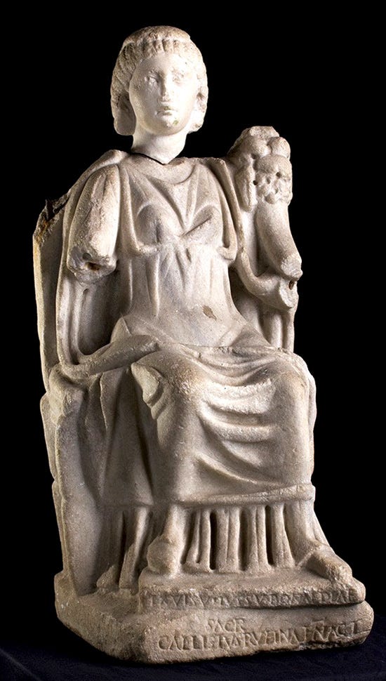 Marble statue of Bona Dea, seated on a chair. The inscription at the base reads “Ex visu iussu Bonae Deae sacr(um) Callistus Rufinae N(ostrae) Act(or)” — in translation, “Statue dedicated to Bona Dea by Callistus, agent of our Rufina, because of a vision, by order (of the goddess).”