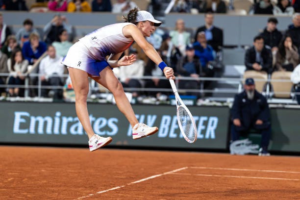 Iga Swiatek of Poland serves against Naomi Osaka of Japan on Court Philippe-Chatrier during the second round of the 2024 French Open Tennis...