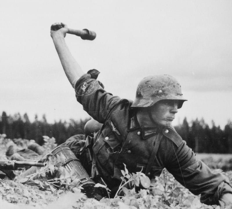 german soldier throwing grenade in ww2