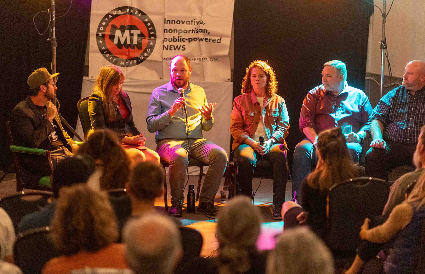 panelists on stage with MT Free Press banner behind