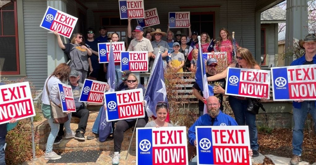 Members of Texas Nationalist Movement holding signs