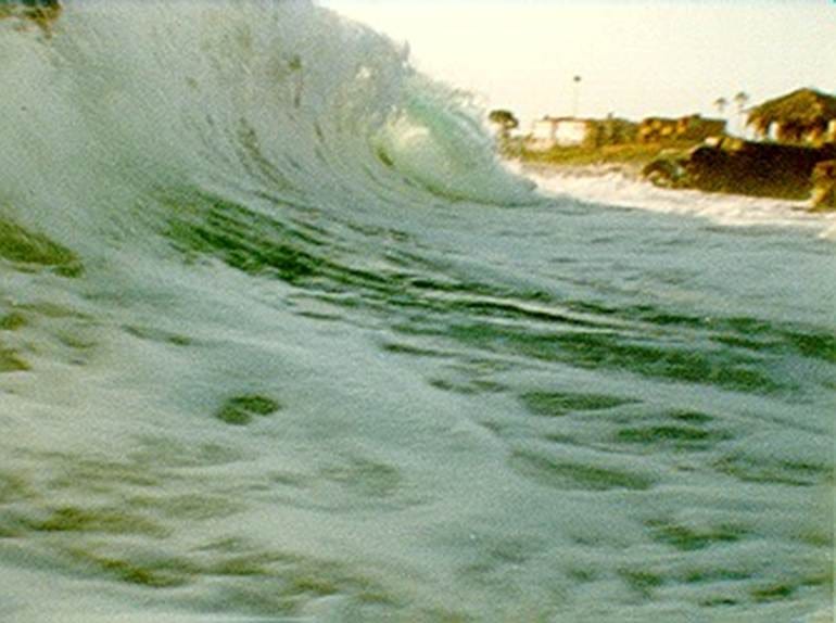 A wave crashing on the beach