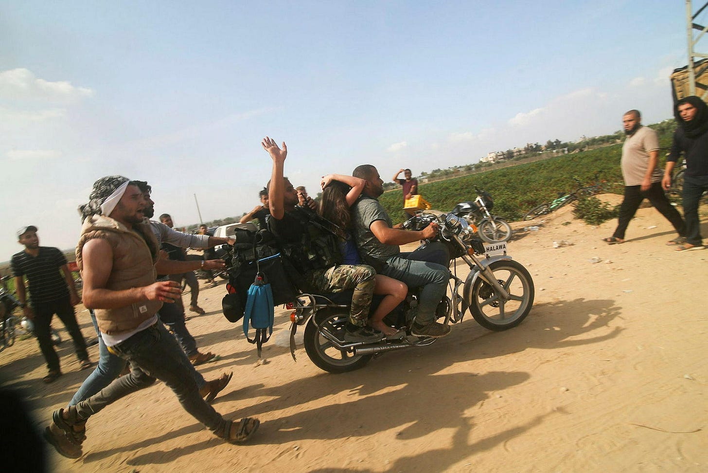 Palestinians taking a hostage from Israel into Gaza.